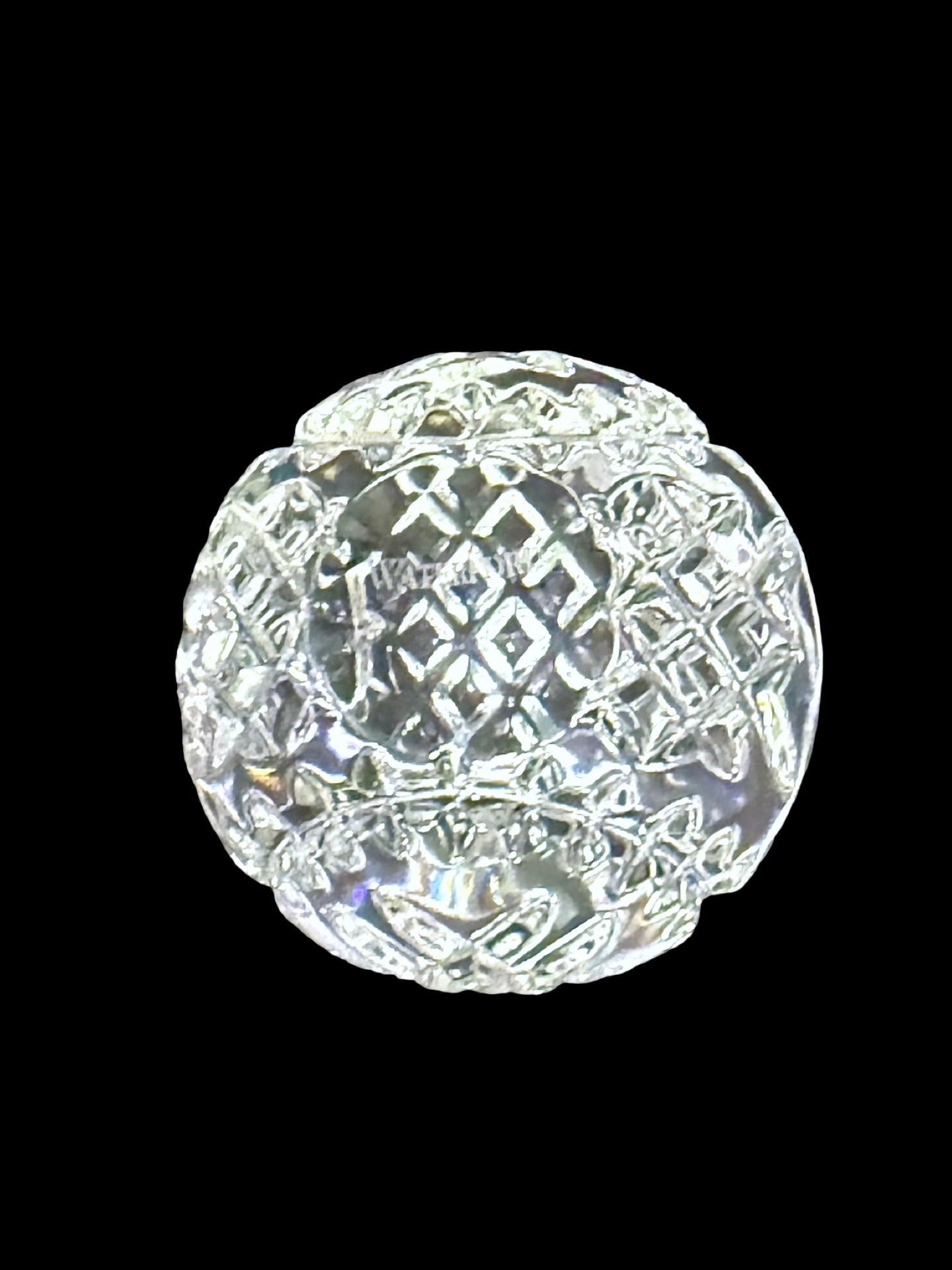 Waterford crystal faceted round paperweight, three-quarter view on black background