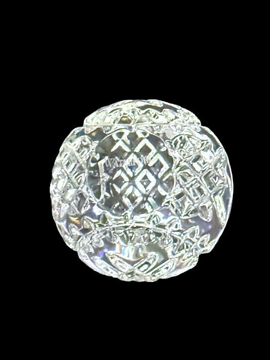 Waterford crystal faceted round paperweight, three-quarter view on black background